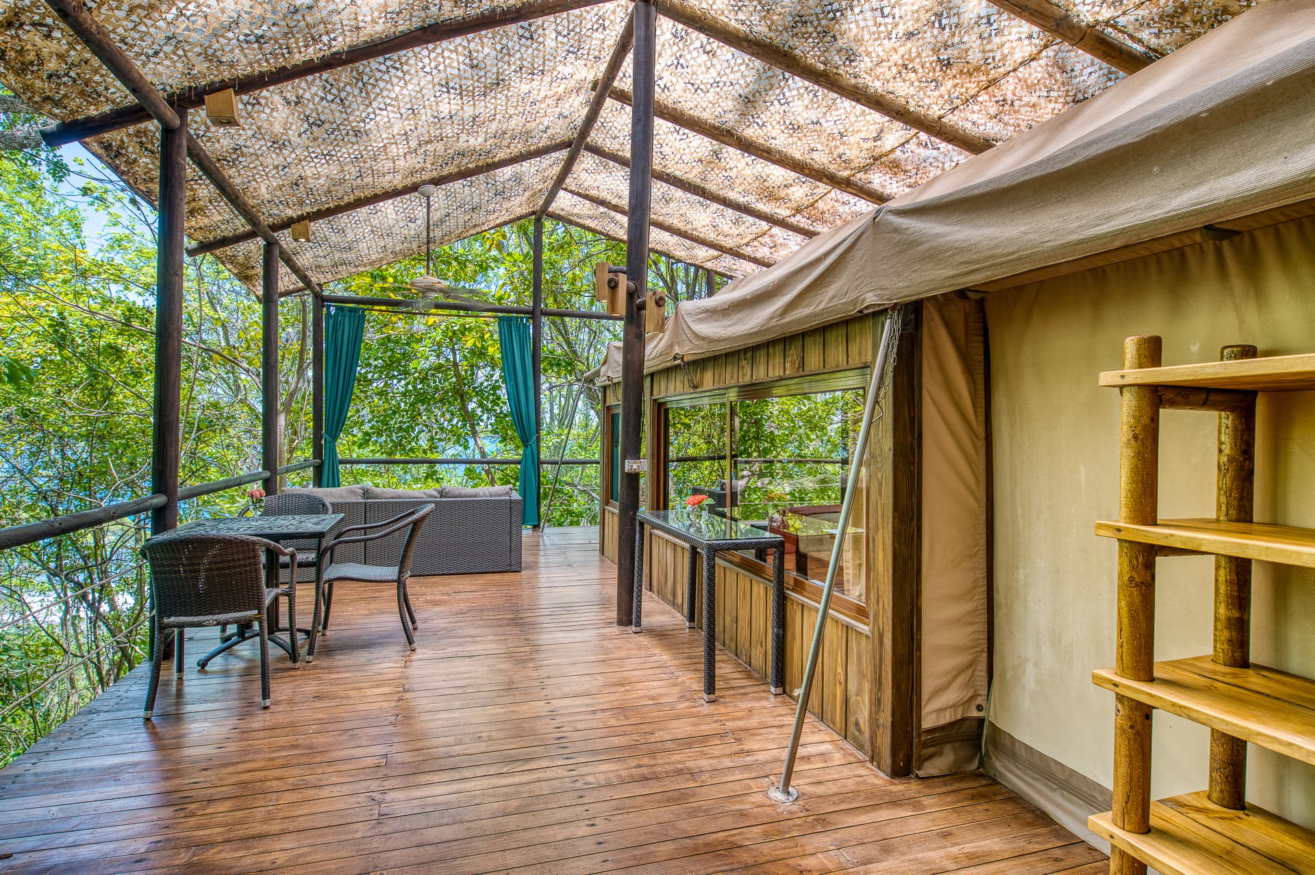 Tree Top Canopy terrace with covered, open-air seating area with jungle views and ocean views through the trees