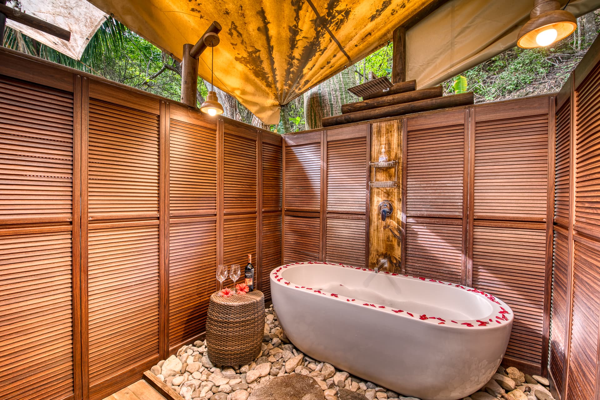 Covered outdoor shower with deep tub surrounded by wooden paneling