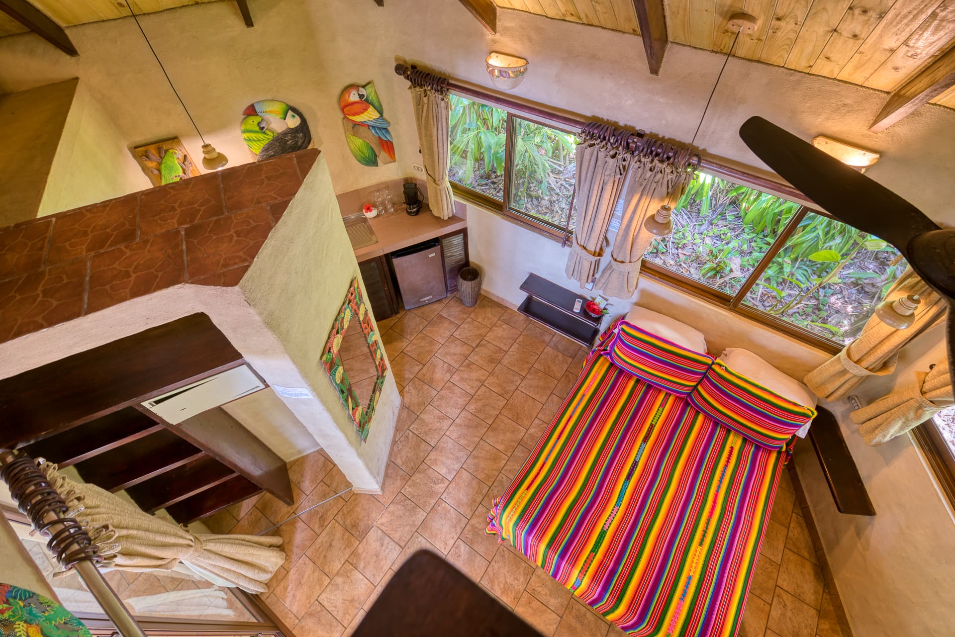 View from the loft looking down to main floor with bed and kitchette area