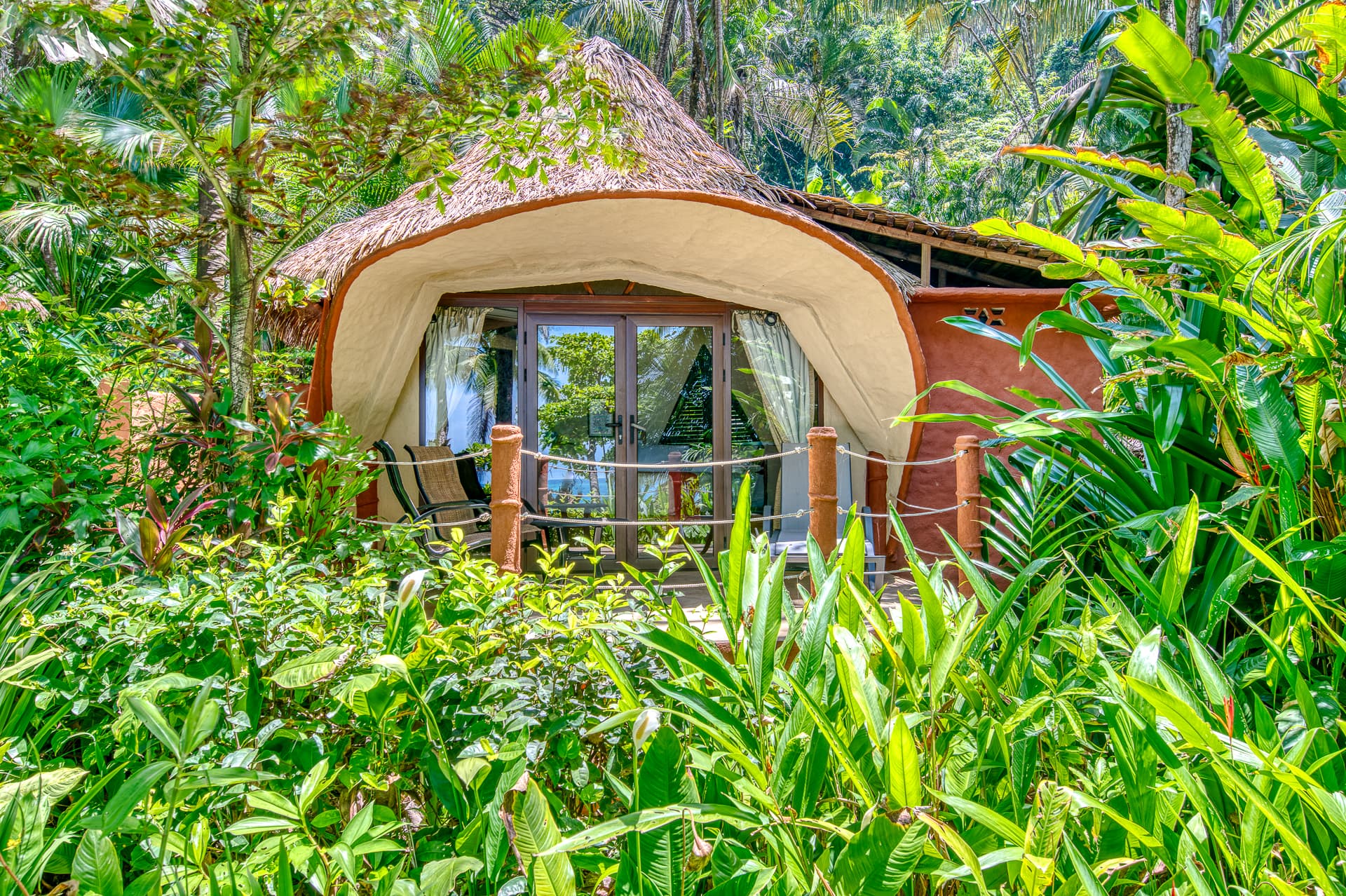 Bungalow surrounded by lush tropical jungle