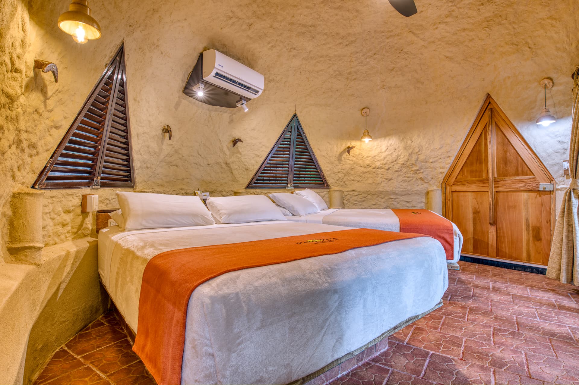 Colibri Bungalow bedroom decorated in warm, neutral tones and two queen beds