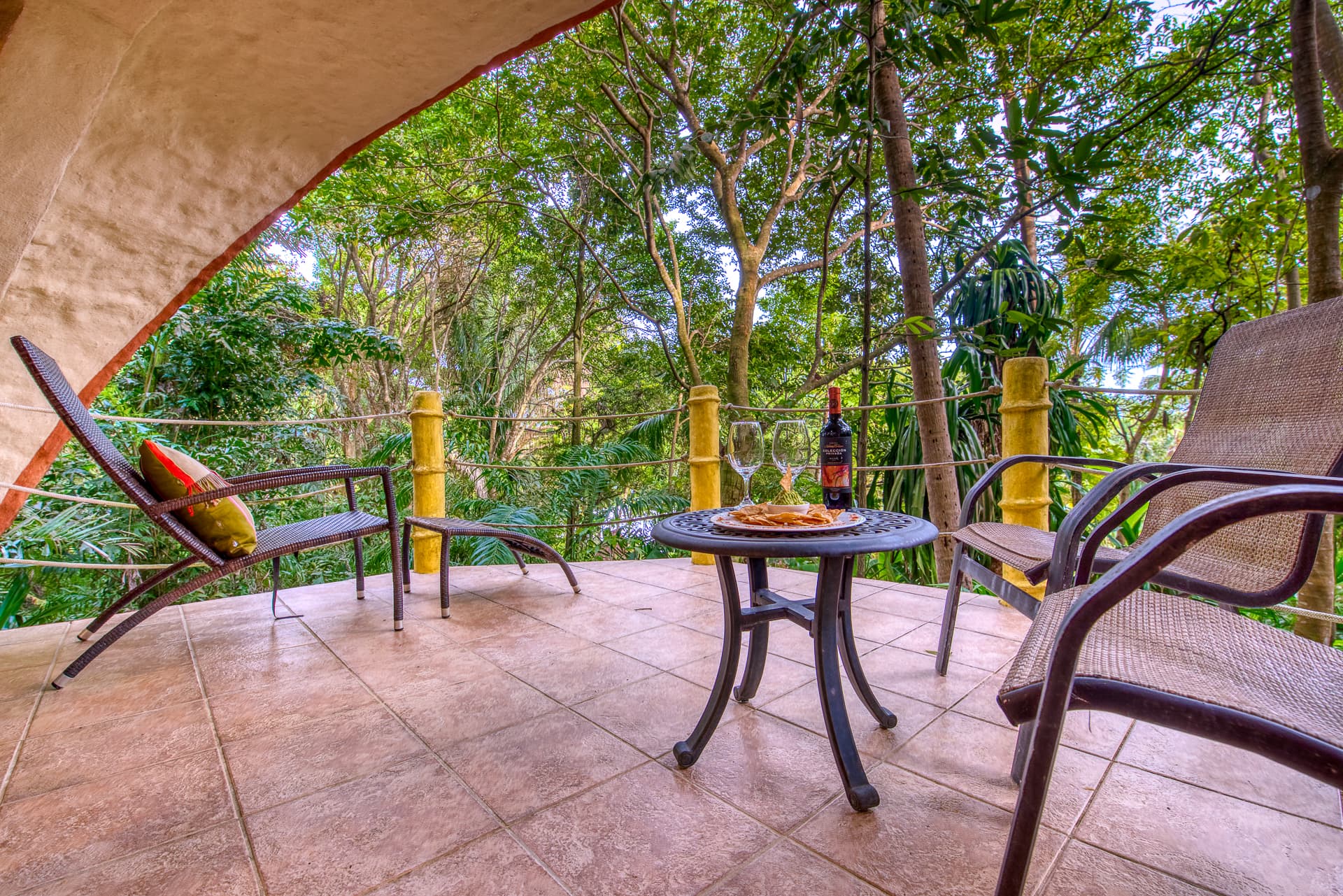 Private Outdoor Terrace at Garden Bungalow with chairs and lounge and jungle views
