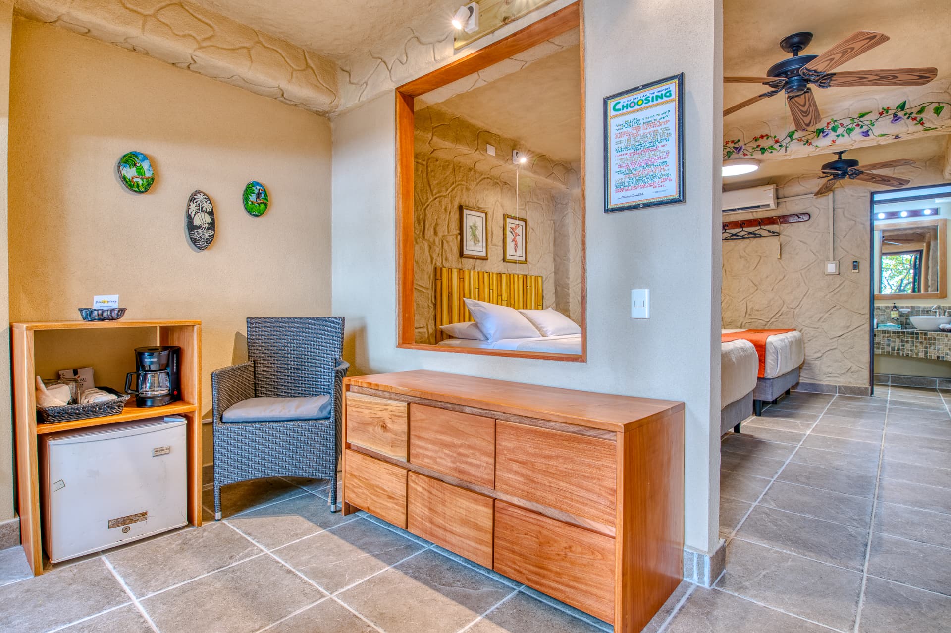 Sitting area with chair, mini fridge, coffee maker and bureau