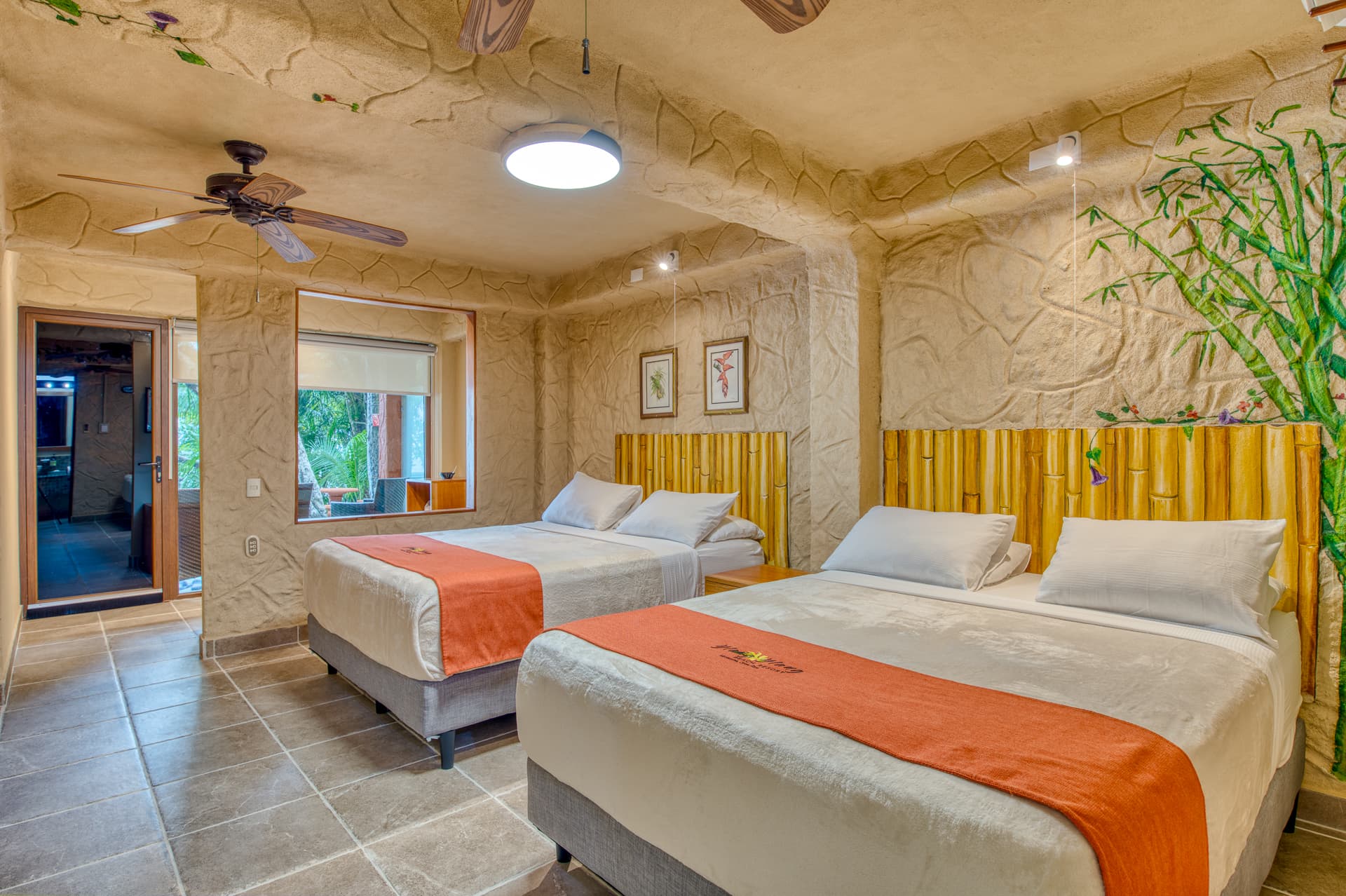 Ground-floor room decorated in warm, neutral tones with two queen beds