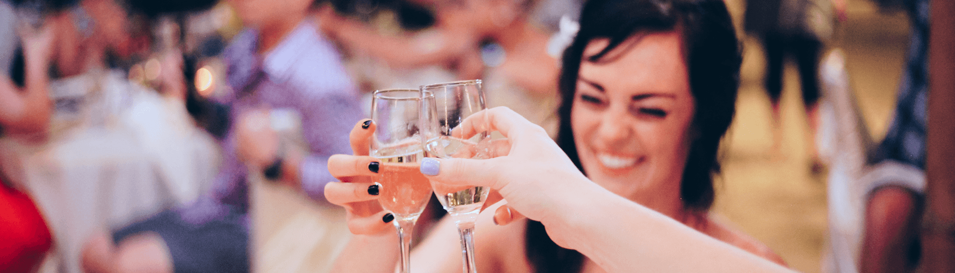 Bride celebrating with champagne flutes with others