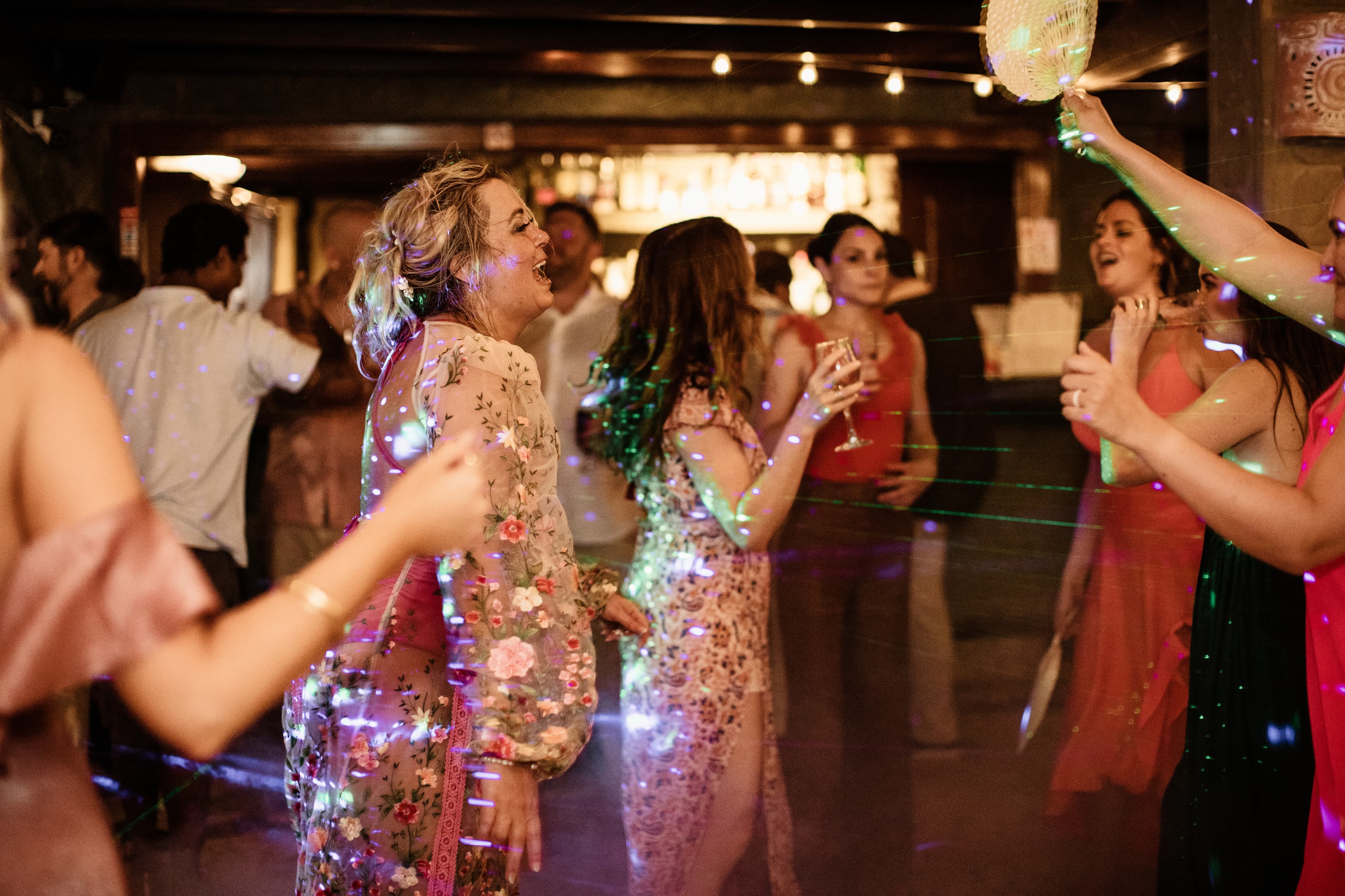 Wedding guests dancing at a nighttime reception