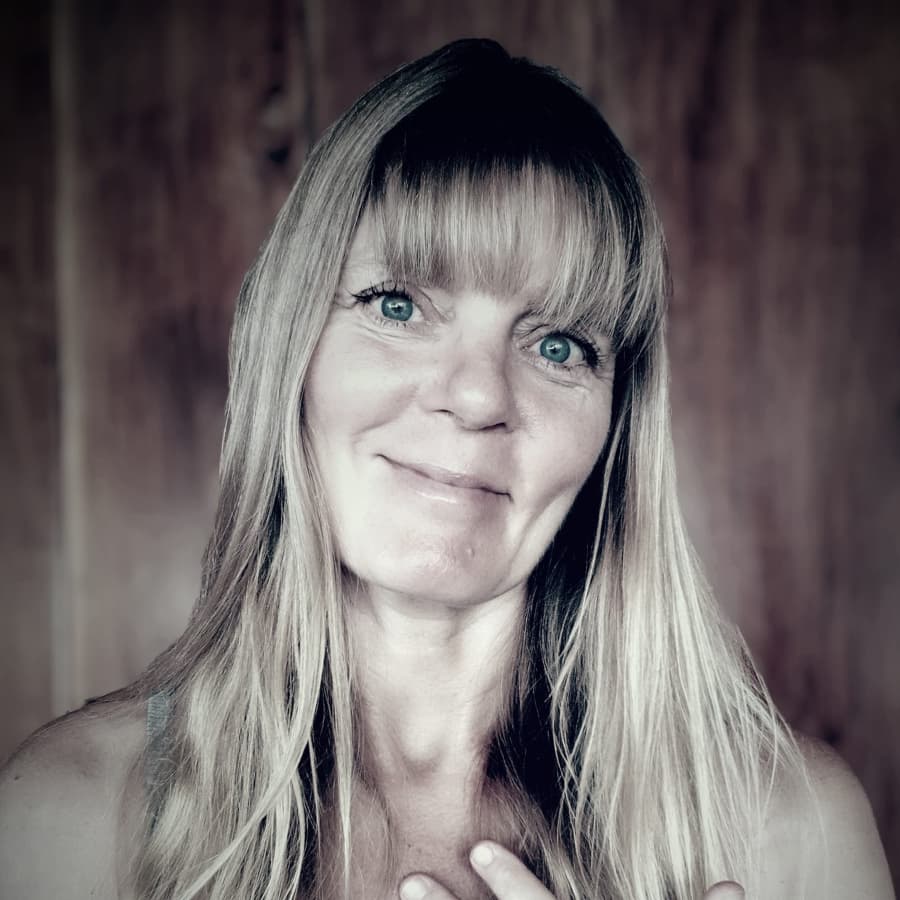 Black and white photo of a woman with bright eyes and long, light-colored hair and bangs