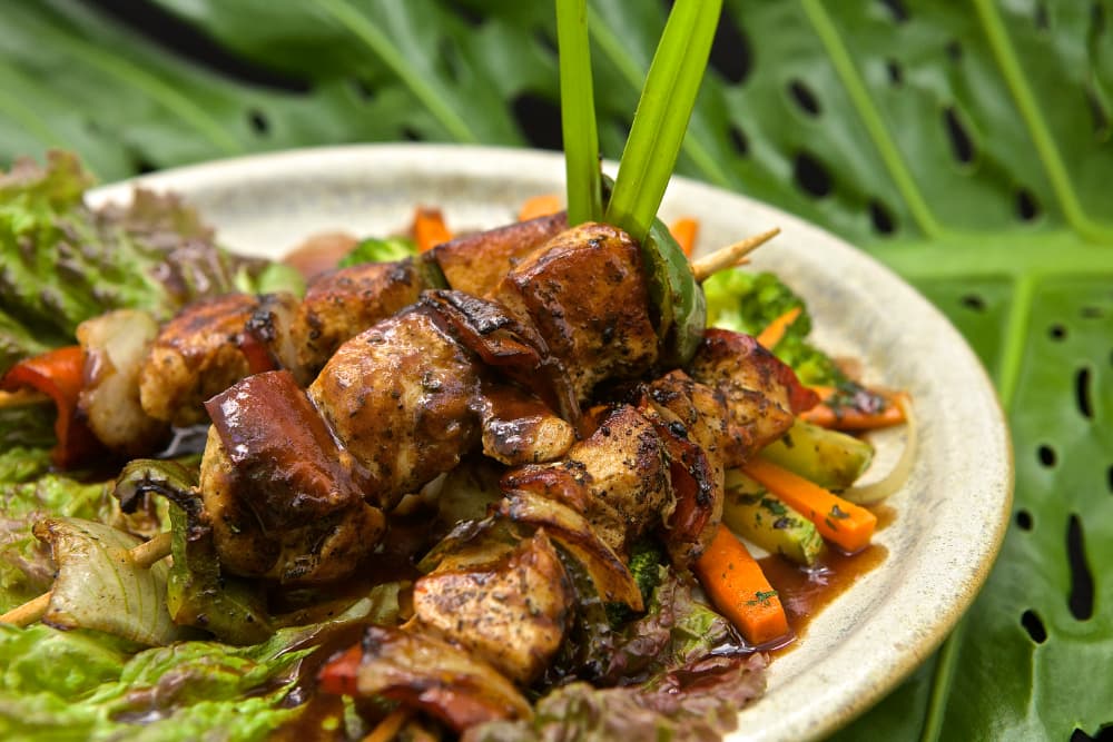 kabobs on bed of vegetables