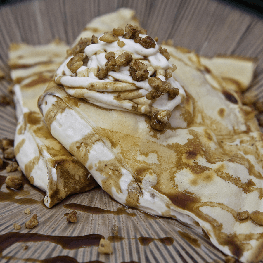Breakfast banana crepe, topped with fresh nut praline and vanilla expresso syrup