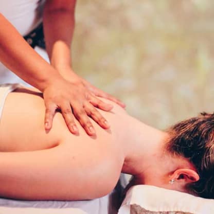 Close up of a woman's hands massaging the neck of another woman